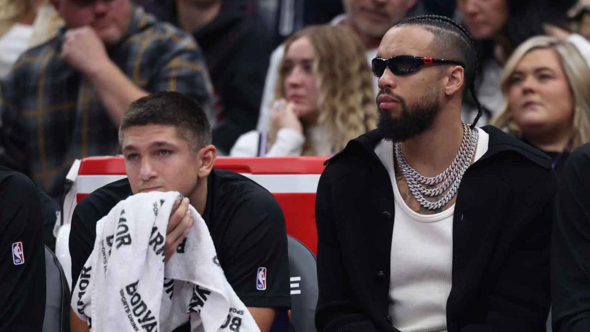 Phoenix Suns guard Grayson Allen (left) and forward Dillon Brooks (right) watch the game against the Utah Jazz from the bench during the second quarter at Delta Center.