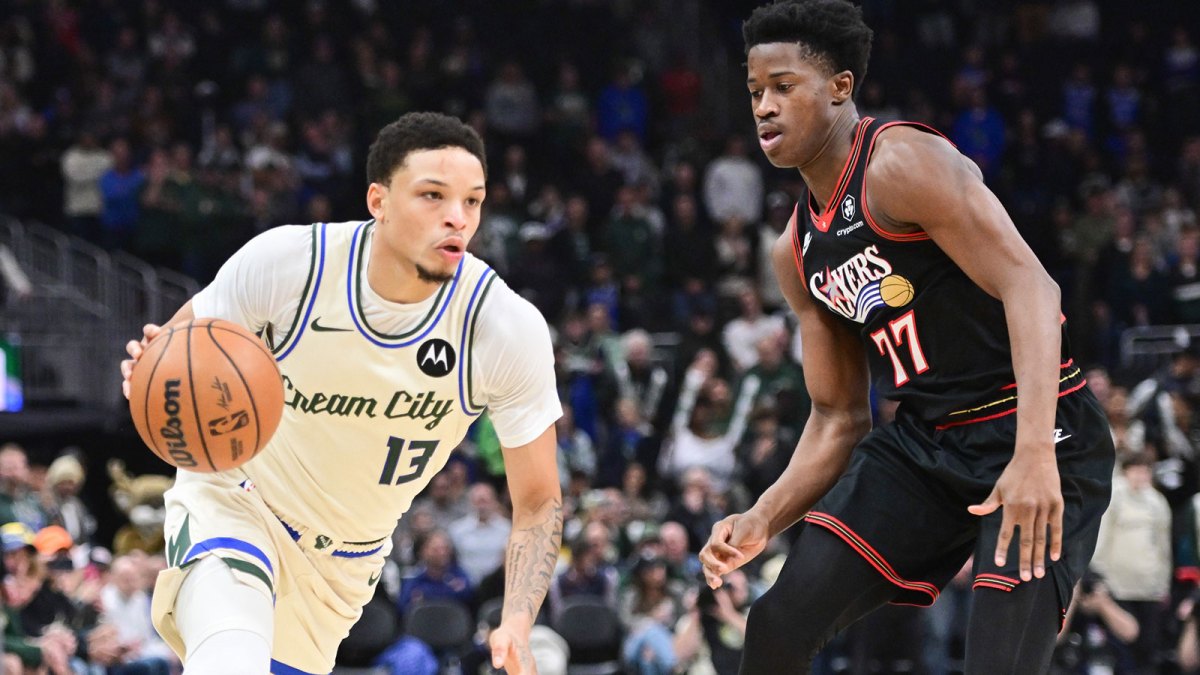 Milwaukee Bucks guard Ryan Rollins (13) drive for the basket against Philadelphia 76ers guard VJ Edgecombe (77) in the first quarter at Fiserv Forum.