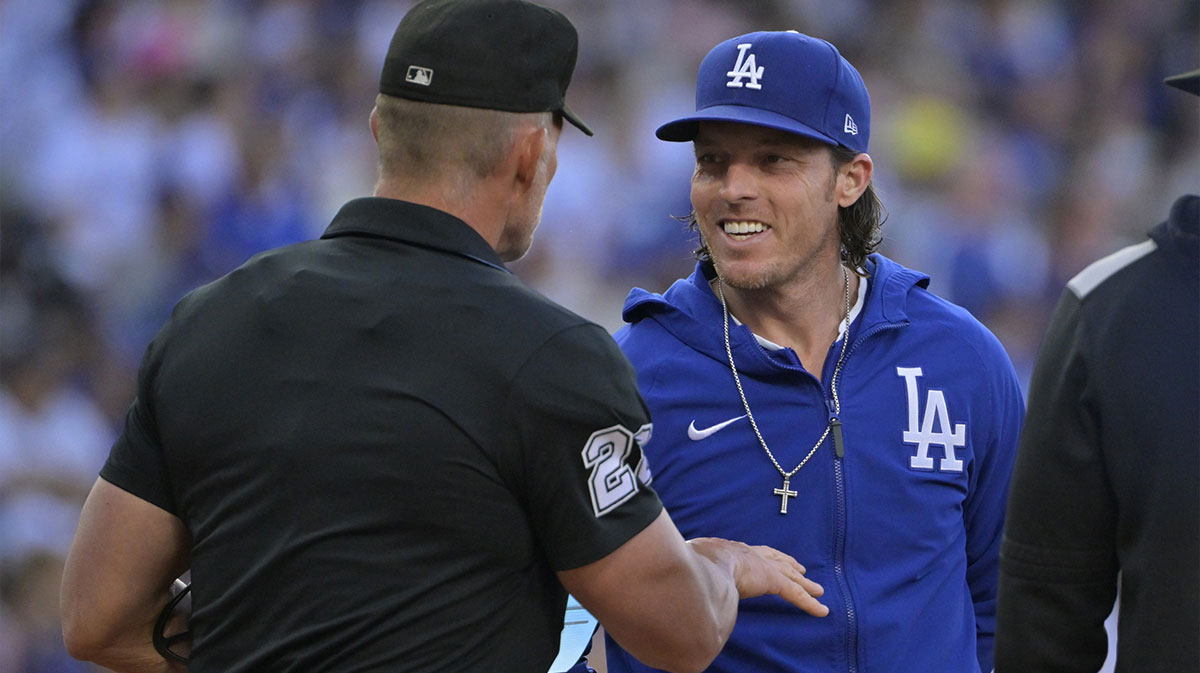 Los Angeles Dodgers bench coach Danny Lehmann (0) talks with umpire Jim Wolf (28) prior to the game against the Chicago White Sox at Dodger Stadium.