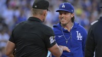 Los Angeles Dodgers bench coach Danny Lehmann (0) talks with umpire Jim Wolf (28) prior to the game against the Chicago White Sox at Dodger Stadium.
