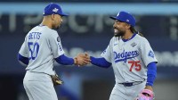Los Angeles Dodgers shortstop Mookie Betts (50) and center fielder Justin Dean (75) celebrate after defeating the Toronto Blue Jays during game six of the 2025 MLB World Series at Rogers Centre.