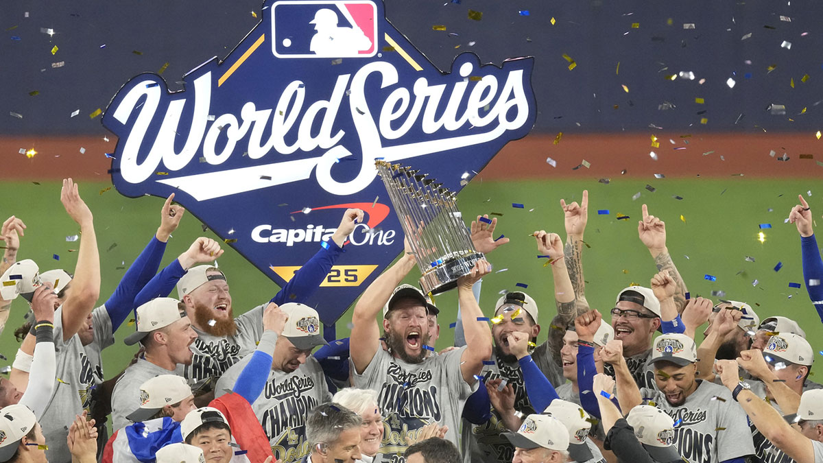 Los Angeles Dodgers pitcher Clayton Kershaw (22) celebrates with the Commissioner's Trophy after defeating the Toronto Blue Jays in game seven of the 2025 MLB World Series at Rogers Centre.