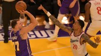 Los Angeles Lakers guard Luka Doncic (77) shoots over Los Angeles Clippers forward John Collins (20) during the first half at Crypto.com Arena.