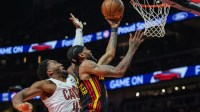 Atlanta Hawks guard Nickeil Alexander-Walker (7) shoots the ball against Cleveland Cavaliers guard Donovan Mitchell (45) during the first quarter at State Farm Arena. Mandatory Credit: Jordan Godfree-Imagn Images