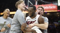 Miami Heat forward Andrew Wiggins (22) reacts to winning the game with teammates against the Cleveland Cavaliers during overtime at Kaseya Center.