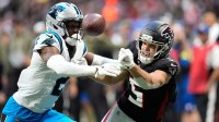 Carolina Panthers cornerback Mike Jackson (2) and Atlanta Falcons wide receiver Drake London (5) battle for the ball in the second half at Mercedes-Benz Stadium.