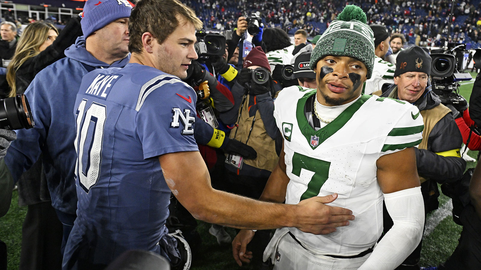 New England Patriots quarterback Drake Maye (10) and New York Jets quarterback Justin Fields (7) react after the game at Gillette Stadium.