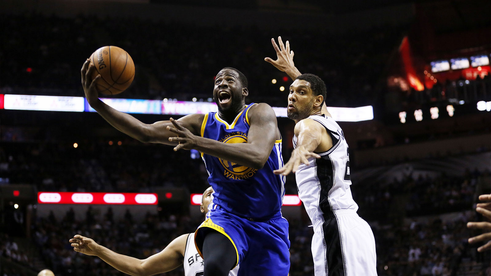 Golden State Warriors forward Draymond Green (left) shoots the ball past San Antonio Spurs forward Tim Duncan (right) during the second half at AT&T Center. The Spurs won 111-90.