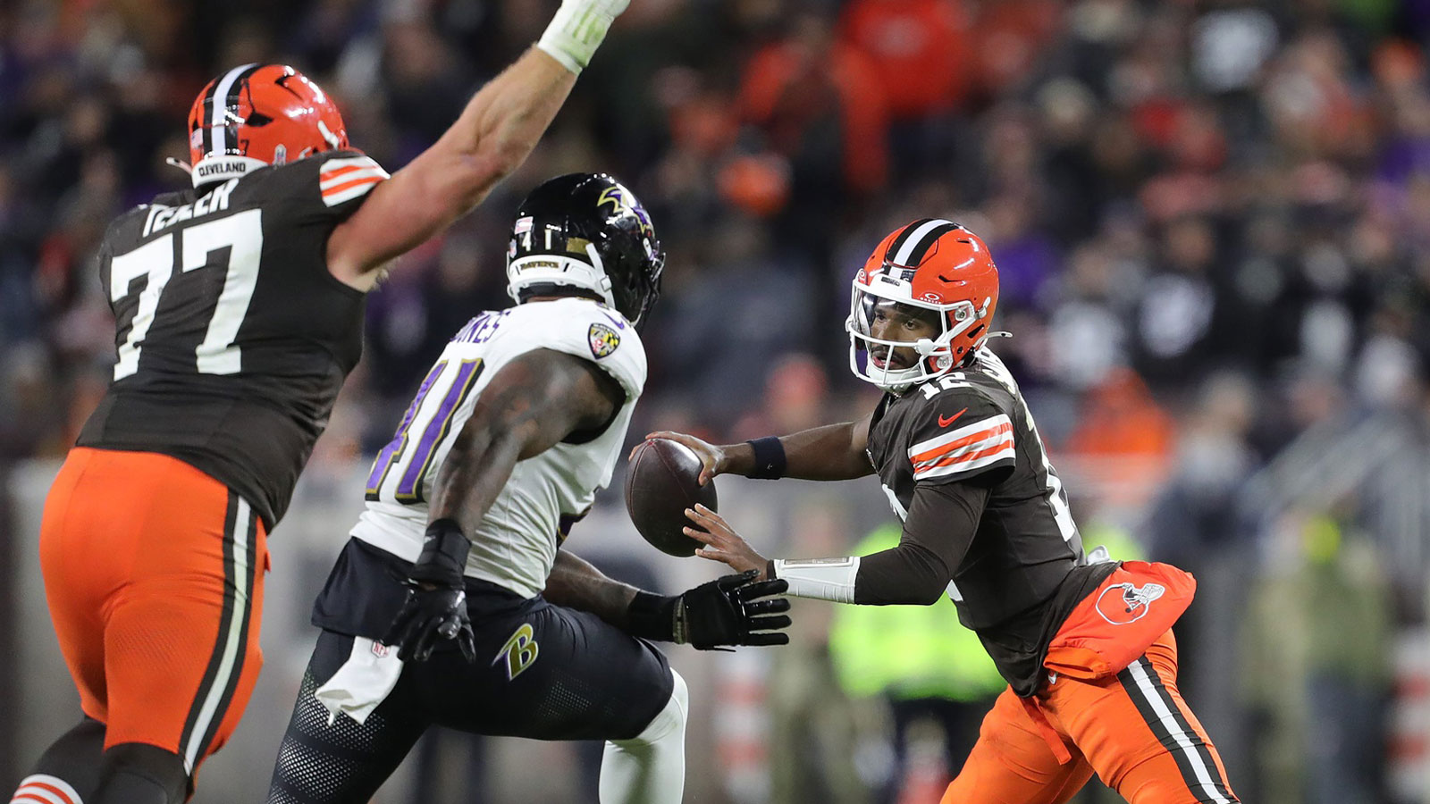 Cleveland Browns quarterback Shedeur Sanders (12) tries to get away from Baltimore Ravens defensive end Dre'Mont Jones (41) during the second half of an NFL football game at Huntington Bank Field, Nov. 16, 2025, in Cleveland, Ohio.