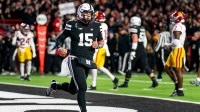 Nebraska Cornhuskers quarterback Dylan Raiola (15) runs off after scoring a touchdown against the Southern California Trojans during the first quarter at Memorial Stadium.