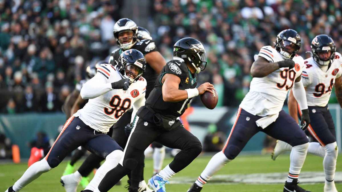 Philadelphia Eagles quarterback Jalen Hurts (1) scrambles with the ball defended by Chicago Bears defensive end Montez Sweat (98) during the first quarter of the game at Lincoln Financial Field.