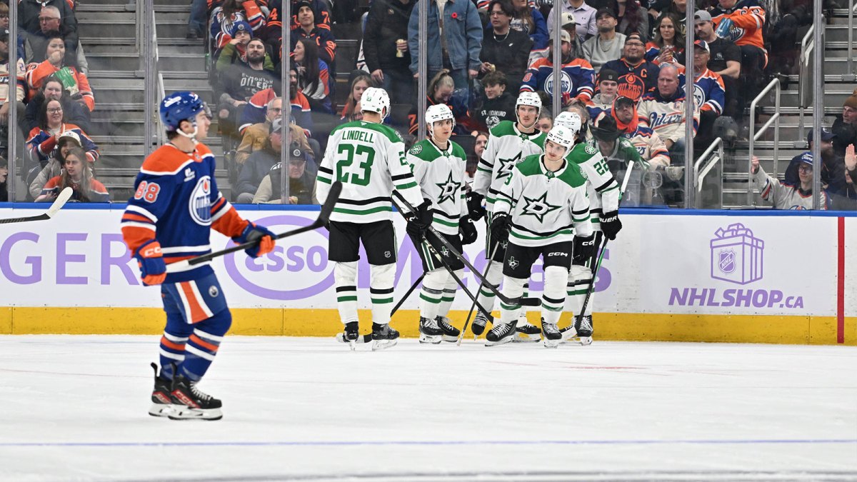 Dallas Stars players celebrate a goal as Edmonton Oilers left winger Andrew Mangiapane (88) skates past during the third period at Rogers Place.