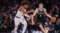 Nov 9, 2025; New York, New York, USA; Brooklyn Nets guard Egor Demin (8) looks to drive past New York Knicks guard Miles McBride (2) in the fourth quarter at Madison Square Garden. Mandatory Credit: Wendell Cruz-Imagn Images