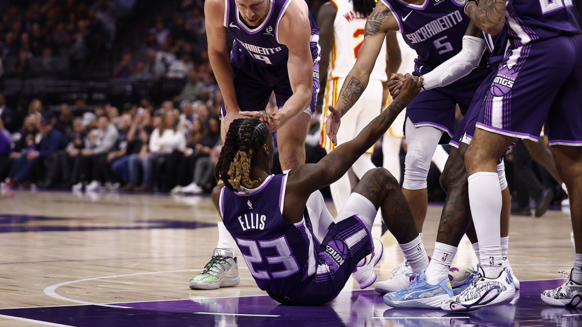 Sacramento Kings teammates help up guard Keon Ellis (23) after drawing an offensive foul against the Atlanta Hawks during the first quarter at Golden 1 Center.