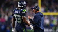 Seattle Seahawks linebacker Ernest Jones IV (13) talks with Seattle Seahawks head coach Mike Macdonald during the fourth quarter against the Houston Texans at Lumen Field.