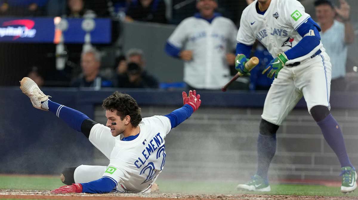 Toronto Blue Jays third baseman Ernie Clement (22) slides into home plate to score a run against the Los Angeles Dodgers in the sixth inning for game seven of the 2025 MLB World Series at Rogers Centre.