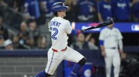 Toronto Blue Jays third baseman Ernie Clement (22) hits a double against the Los Angeles Dodgers in the eighth inning during game seven of the 2025 MLB World Series at Rogers Centre.