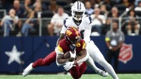 Dallas Cowboys cornerback Kaiir Elam (20) tackles Washington Commanders running back Jacory Croskey-Merritt (22) during the first quarter of the game at AT&T Stadium.