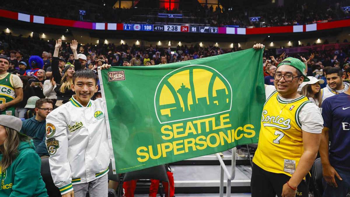 Fans hold a flag for the Seattle Supersonics during the fourth quarter of a game between the Utah Jazz and LA Clippers at Climate Pledge Arena.