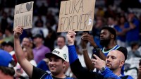 Fans of Los Angeles Lakers guard Luka Doncic (77) hold up signs before the game against the Dallas Mavericks at American Airlines Center.