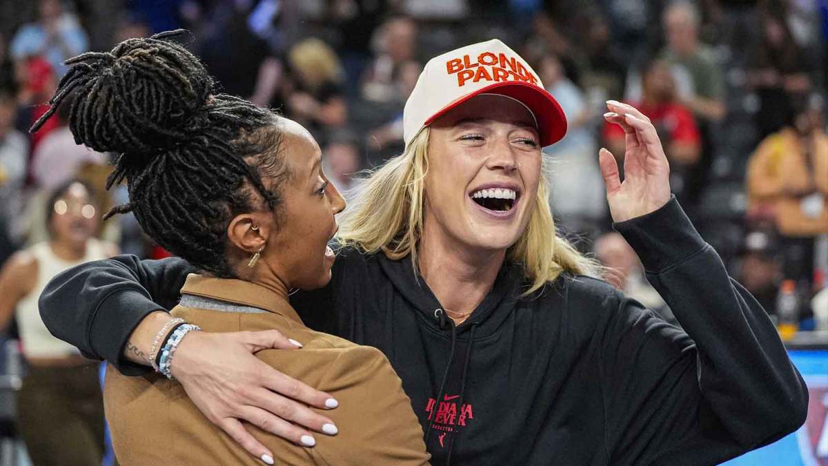 Fever player Sophie Cunningham (hat) reacts after The Fever defeated the Atlanta Dream during game three of round one for the 2025 WNBA Playoffs at Gateway Center Arena at College Park with Nets' Michael Porter Jr. in the background