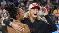 Fever player Sophie Cunningham (hat) reacts after The Fever defeated the Atlanta Dream during game three of round one for the 2025 WNBA Playoffs at Gateway Center Arena at College Park with Nets' Michael Porter Jr. in the background