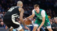 Dallas Mavericks forward Cooper Flagg (32) dribbles as Milwaukee Bucks forward Kyle Kuzma (18) defends during the third quarter at American Airlines Center.