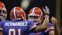 Florida Gators tight end Aaron Hernandez (81) celebrates with quarterback Tim Tebow (15) after scoring a touchdown against the Cincinnait Bearcats during the first half of the 2010 Sugar Bowl at the Louisiana Superdome.