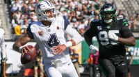 Dallas Cowboys quarterback Dak Prescott (4) looks to pass downfield as New York Jets defensive tackle Quinnen Williams (95) defends during the first half at MetLife Stadium.