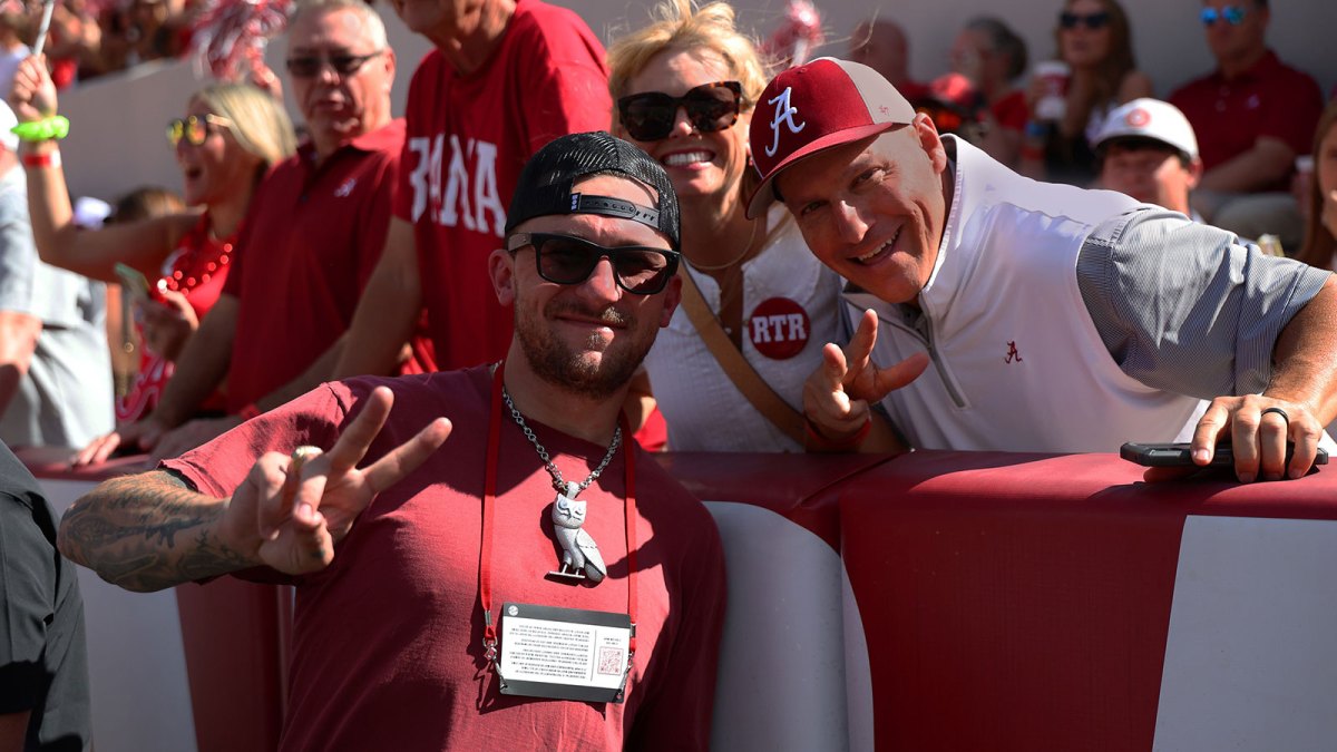 Former Texas A&M Aggies quarterback Johnny Manziel poses with Alabama Crimson Tide fans during a game against the Vanderbilt Commodores at Saban Field at Bryant-Denny Stadium.