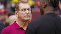 Former professional football players Joe Theismann (left) speaks with Robert Griffin III before the Washington Commanders and Arizona Cardinals game at FedExField.