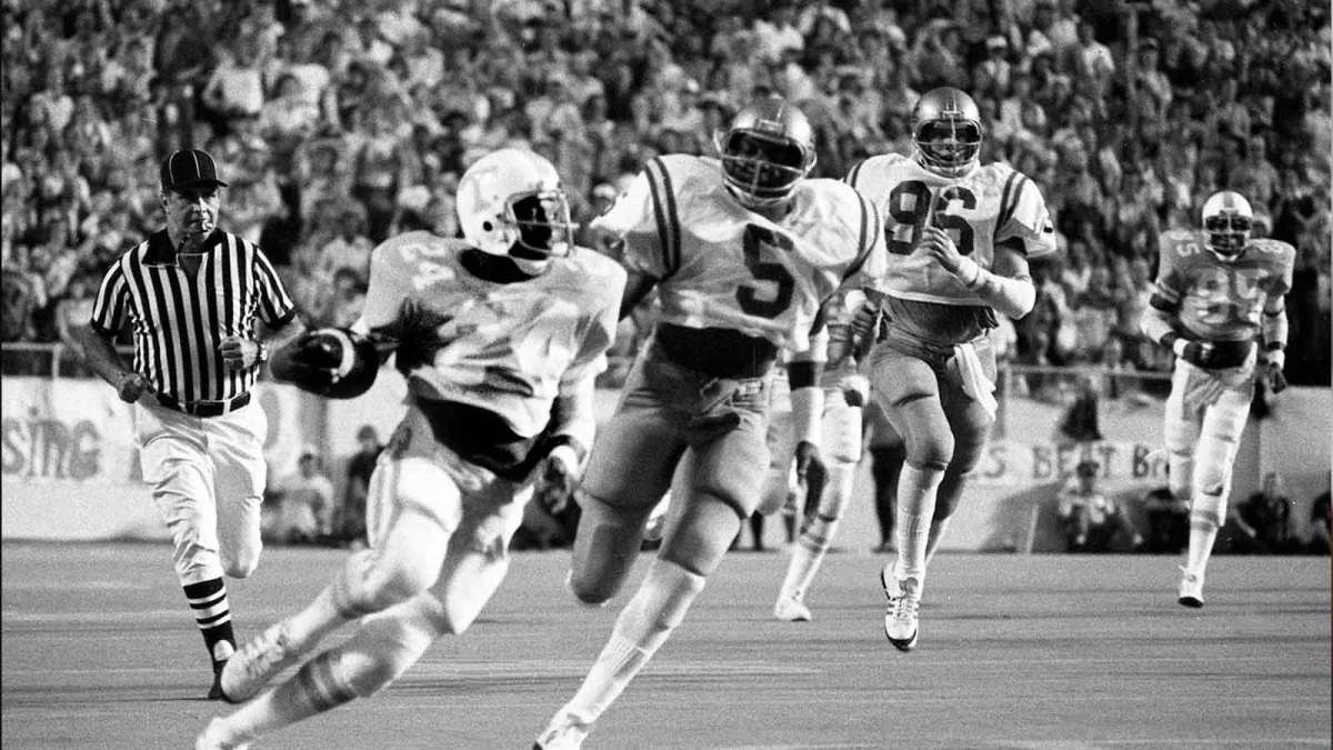 Spry Tennessee running back Frank Foxx (24) picks up some big yardages on a return as UCLA teammates Kenny Easley (5) and Don Hopwood (96) give chase. But the Vols fall 13-0 to UCLA before an opening record crowd of 85,897 at Neyland Stadium Sept. 16, 1978.