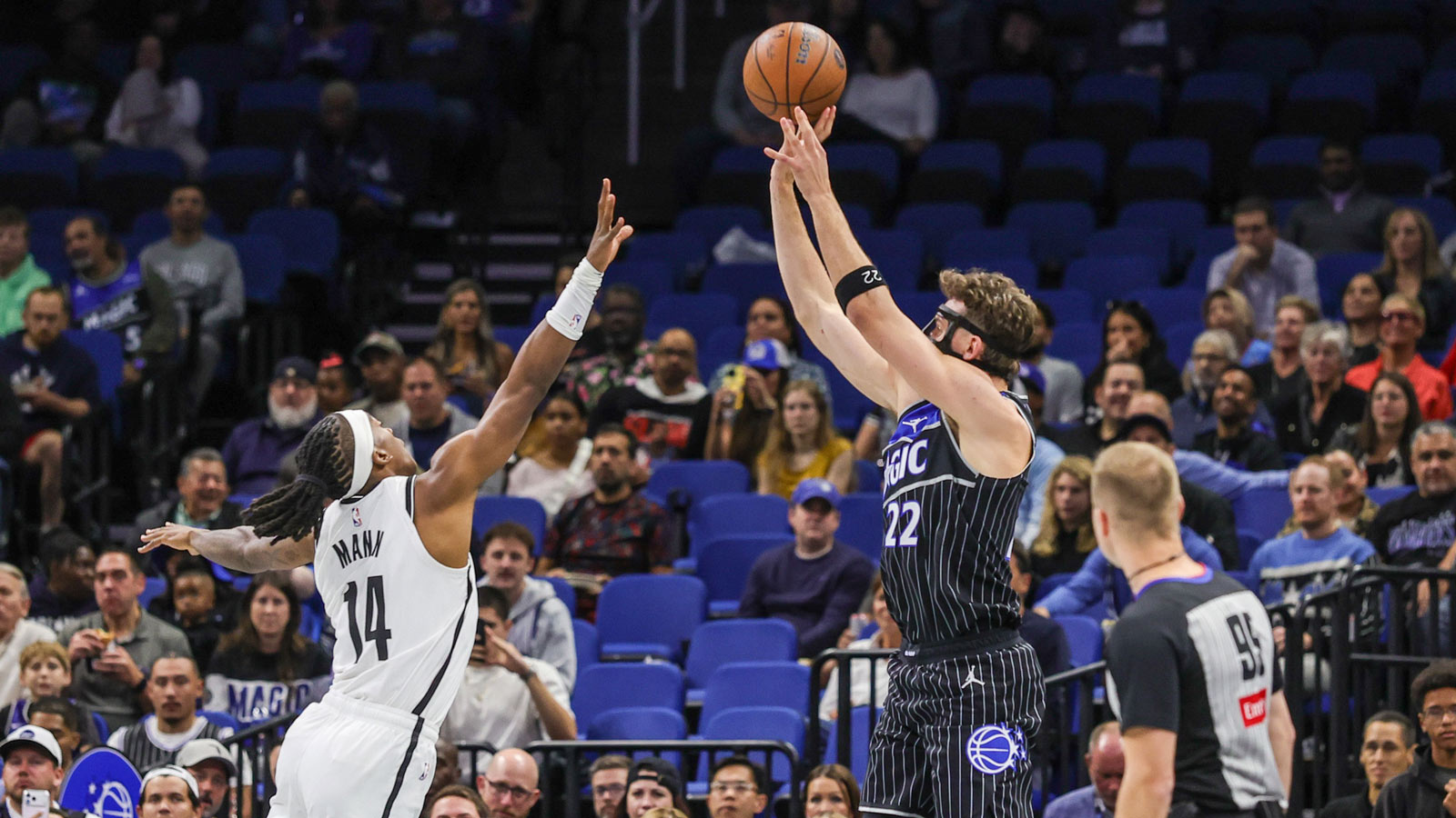 Nov 14, 2025; Orlando, Florida, USA; Orlando Magic forward Franz Wagner (22) shoots against Brooklyn Nets guard Terance Mann (14) during the first quarter at Kia Center.
