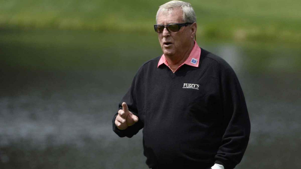 Fuzzy Zoeller waves to the crowd as he walks to the 4th green during the Par 3 Contest prior to the 2016 The Masters golf tournament at Augusta National Golf Club