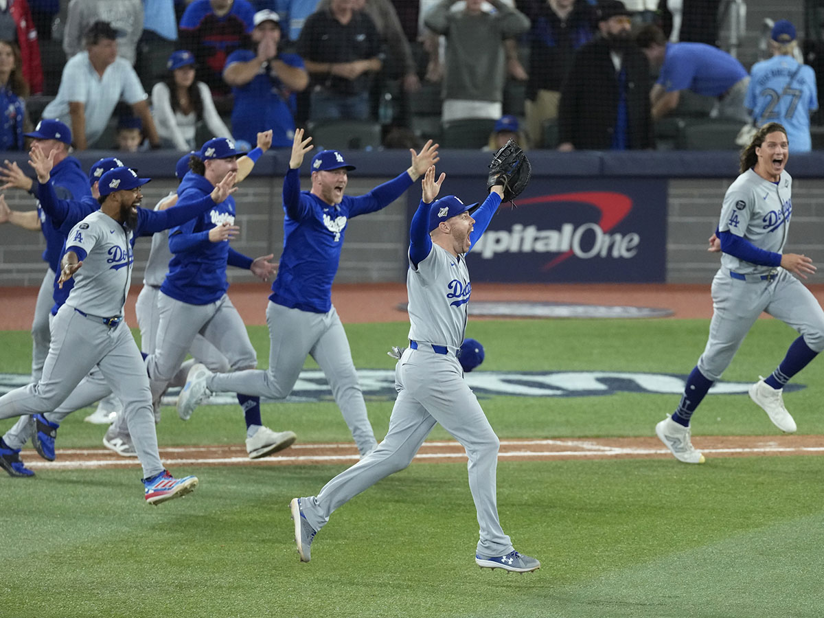 Los Angeles Dodgers first baseman Freddie Freeman (5) celebrates with teammates after defeating the Toronto Blue Jays during game seven of the 2025 MLB World Series at Rogers Centre.