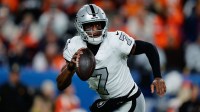 Las Vegas Raiders quarterback Geno Smith (7) scrambles with the ball in the fourth quarter against the Denver Broncos at Empower Field at Mile High.