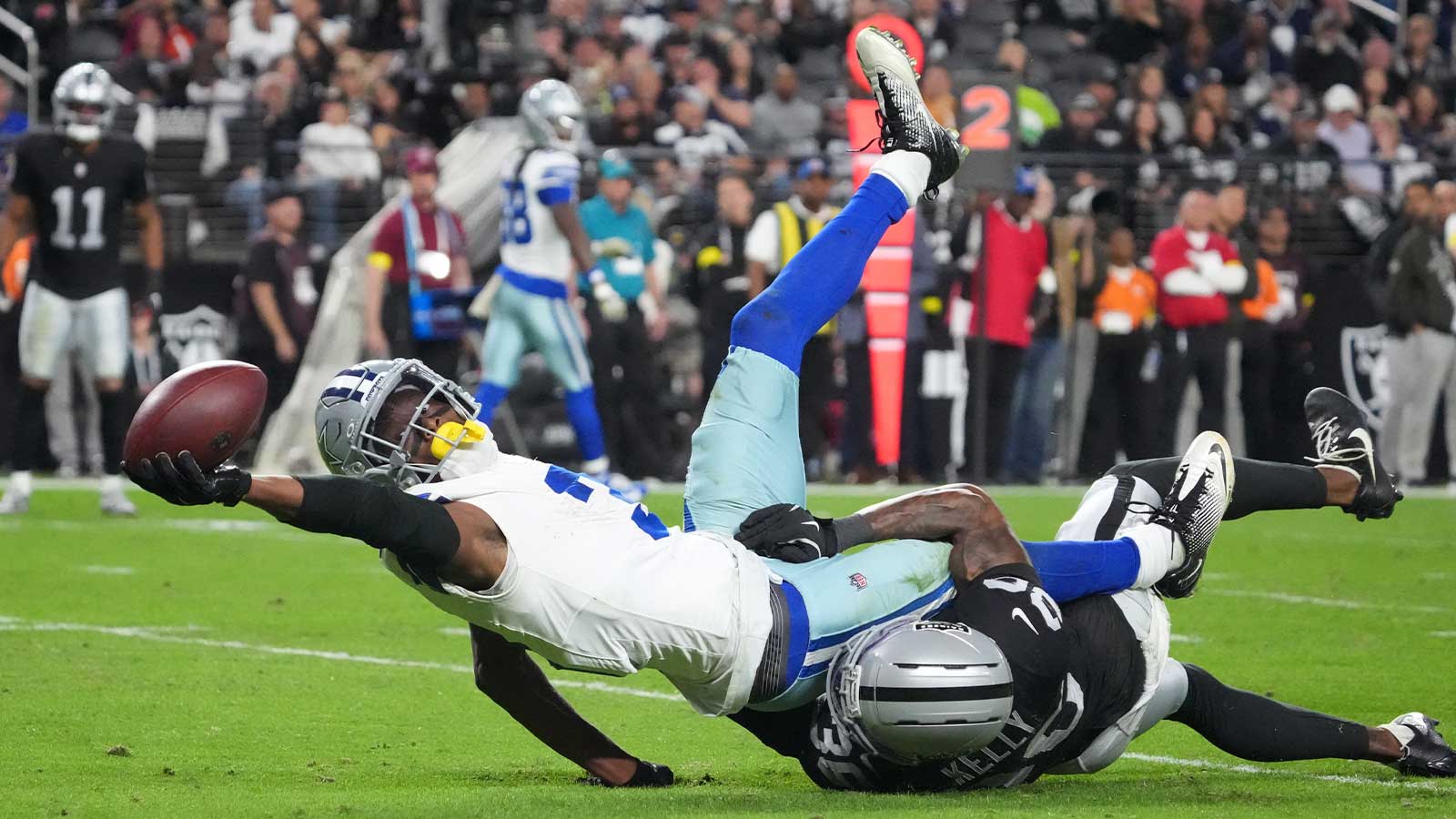 Dallas Cowboys wide receiver George Pickens (3) reaches for extra yardage as he is tackled by Las Vegas Raiders cornerback Kyu Blu Kelly (36) during the second half at Allegiant Stadium. 