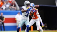 Dallas Cowboys wide receiver George Pickens (3) makes a catch against Denver Broncos cornerback Pat Surtain II (2) in the second quarter at Empower Field at Mile High.