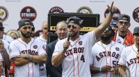 Houston Astros center fielder George Springer (4) talks to the crowd during the World Series championship parade and rally at Houston City Hall.