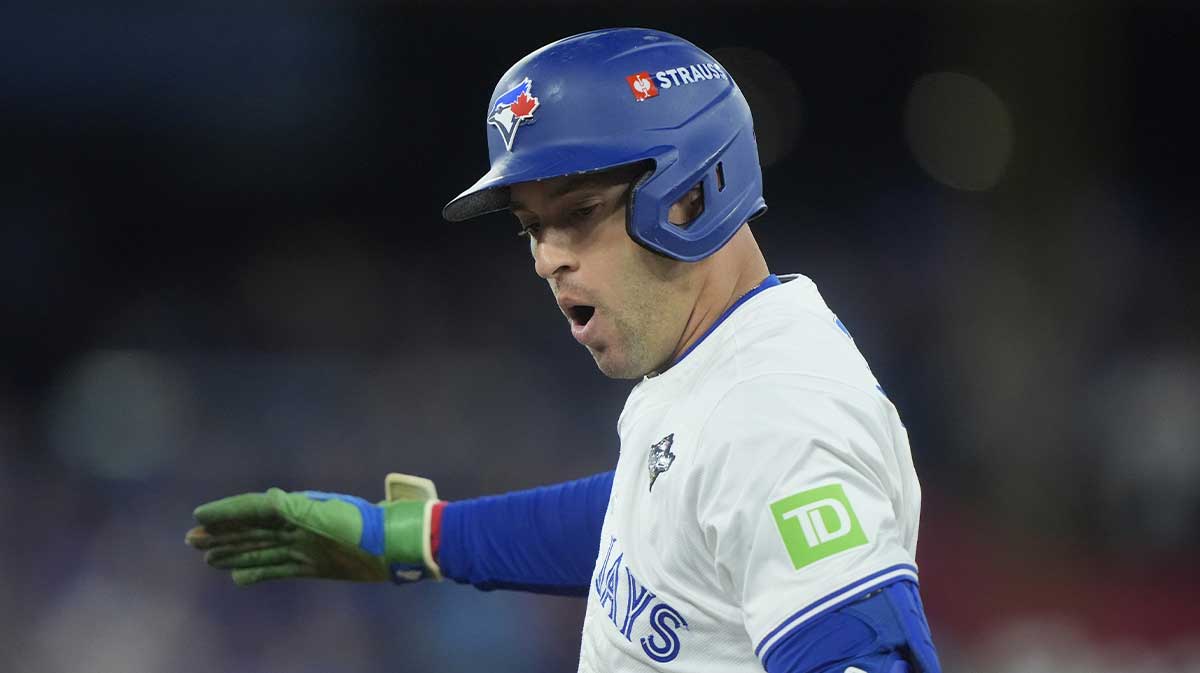 Toronto Blue Jays right fielder George Springer (4) reacts after hitting a single against the Los Angeles Dodgers in the first inning during game seven of the 2025 MLB World Series at Rogers Centre.