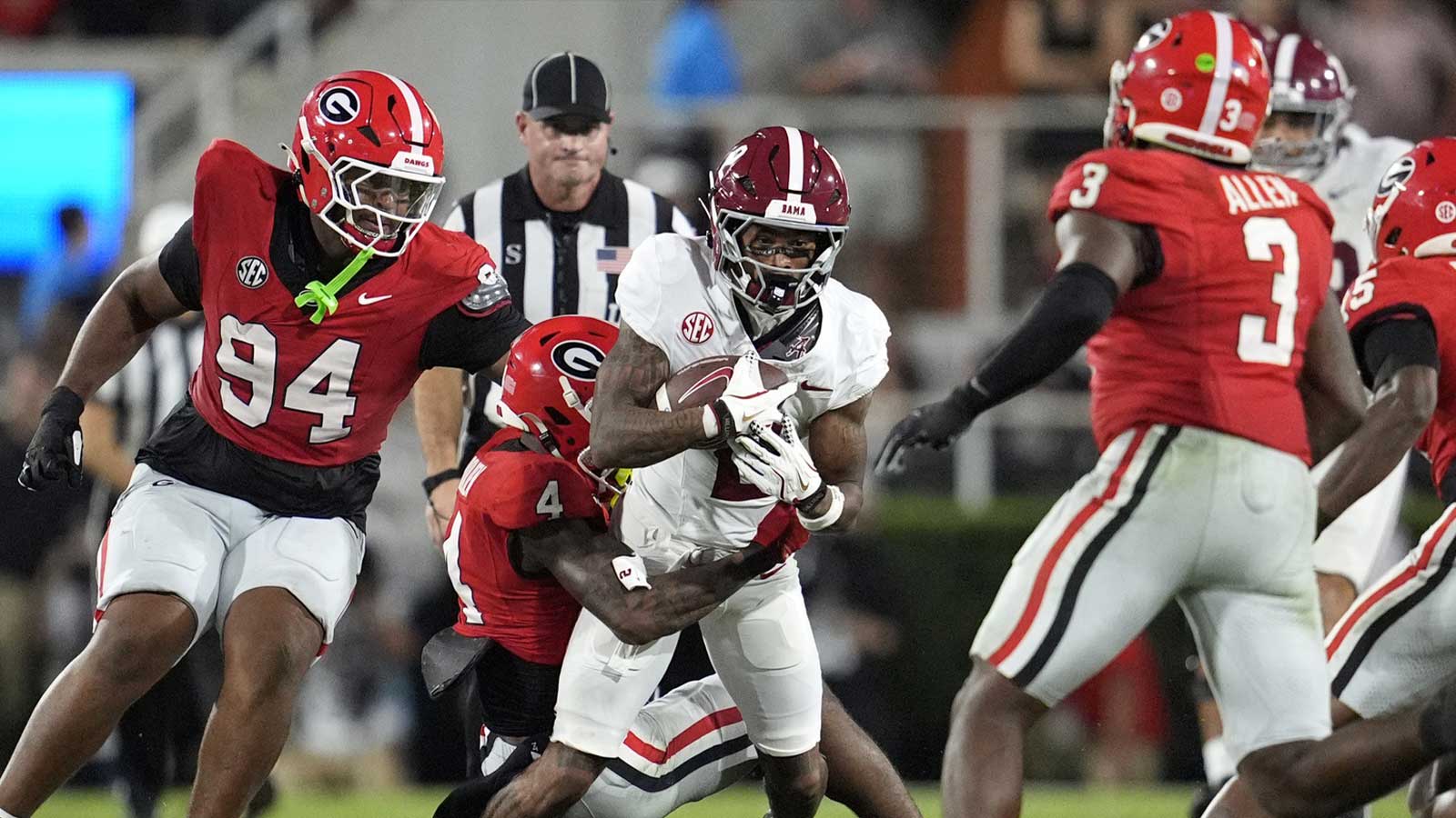 Georgia Bulldogs defensive back KJ Bolden (4) tackles Alabama Crimson Tide wide receiver Ryan Williams (2) in the first half at Sanford Stadium. 