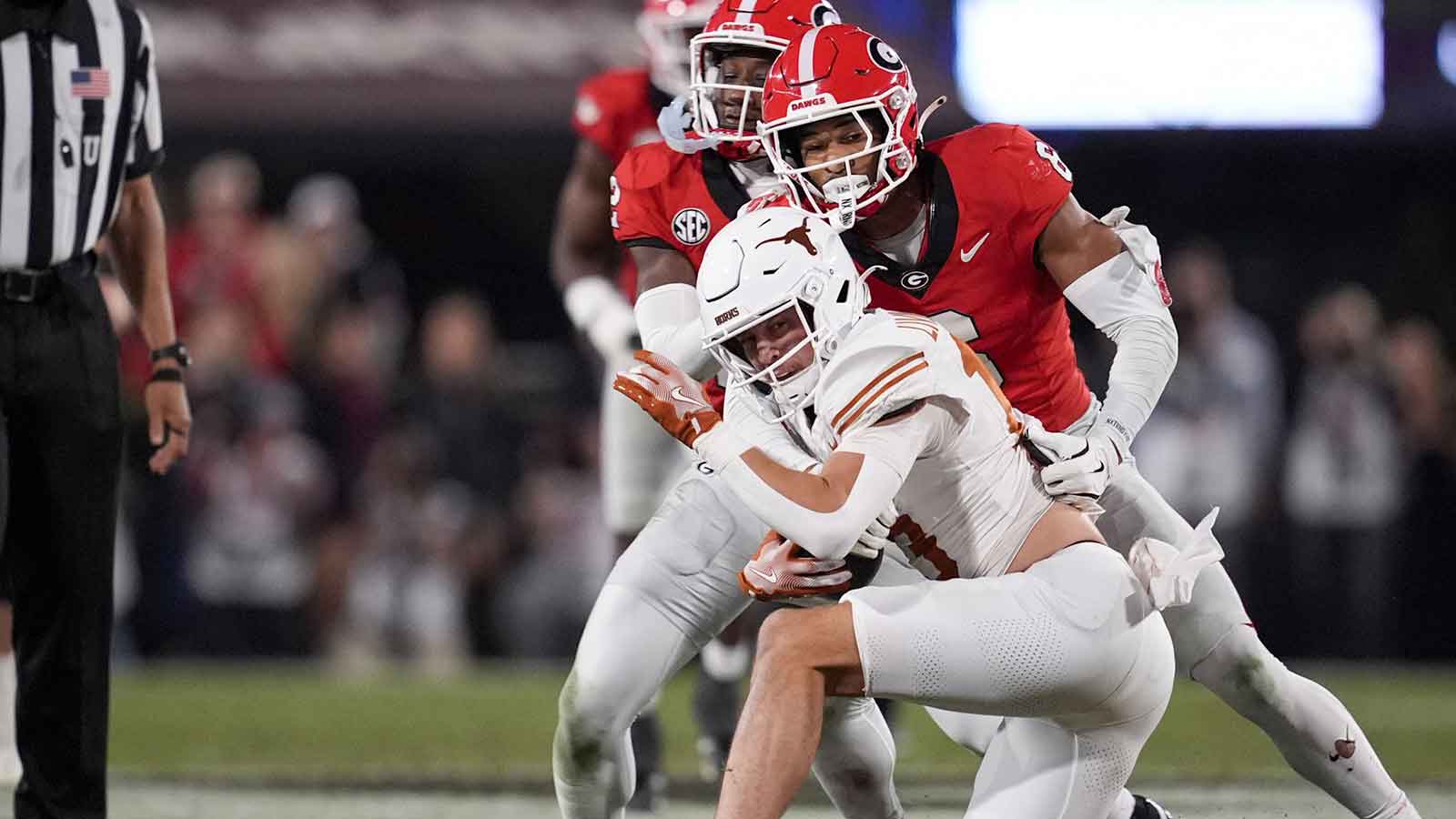 Georgia Bulldogs defensive back Daylen Everette (6) tackles Texas Longhorns quarterback Arch Manning (16) in the second half at Sanford Stadium.