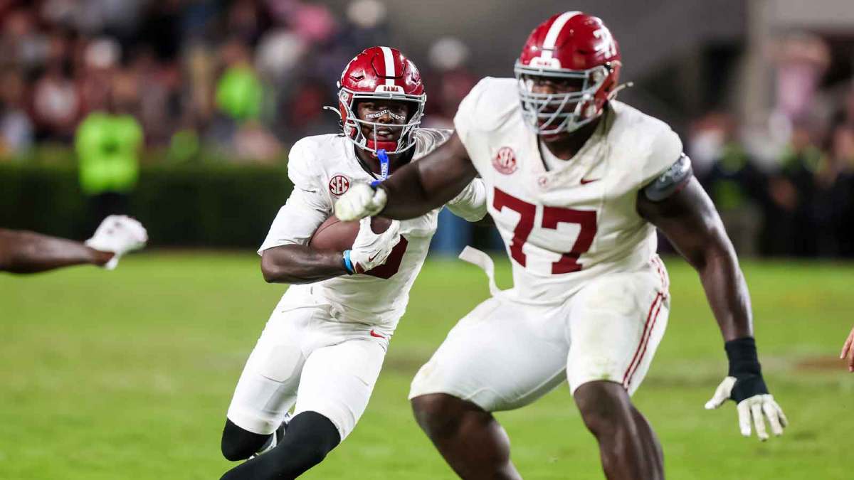 Alabama Crimson Tide offensive lineman Jaeden Roberts (77) blocks for wide receiver Germie Bernard (5) in the second half at Williams-Brice Stadium.