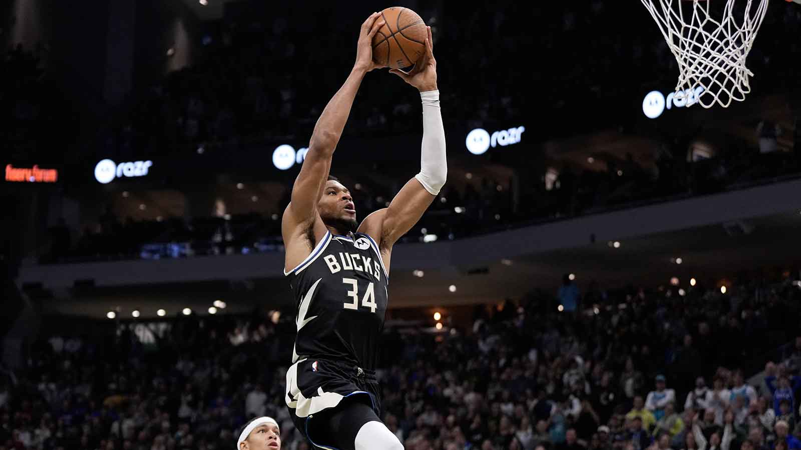 Milwaukee Bucks forward Giannis Antetokounmpo (34) drives for a dunk during overtime against the Charlotte Hornets at Fiserv Forum