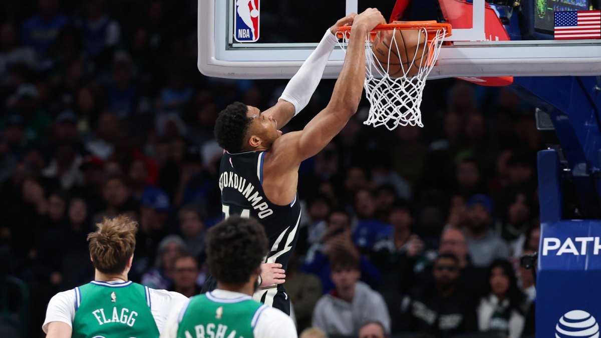 Milwaukee Bucks forward Giannis Antetokounmpo (34) dunks past Dallas Mavericks forward Cooper Flagg (32) during the third quarter at American Airlines Center.