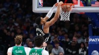 Milwaukee Bucks forward Giannis Antetokounmpo (34) dunks past Dallas Mavericks forward Cooper Flagg (32) during the third quarter at American Airlines Center.