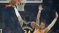 Milwaukee Bucks forward Giannis Antetokounmpo (34) shoots beside Cleveland Cavaliers guard Sam Merrill (5) in the first quarter at Rocket Arena.