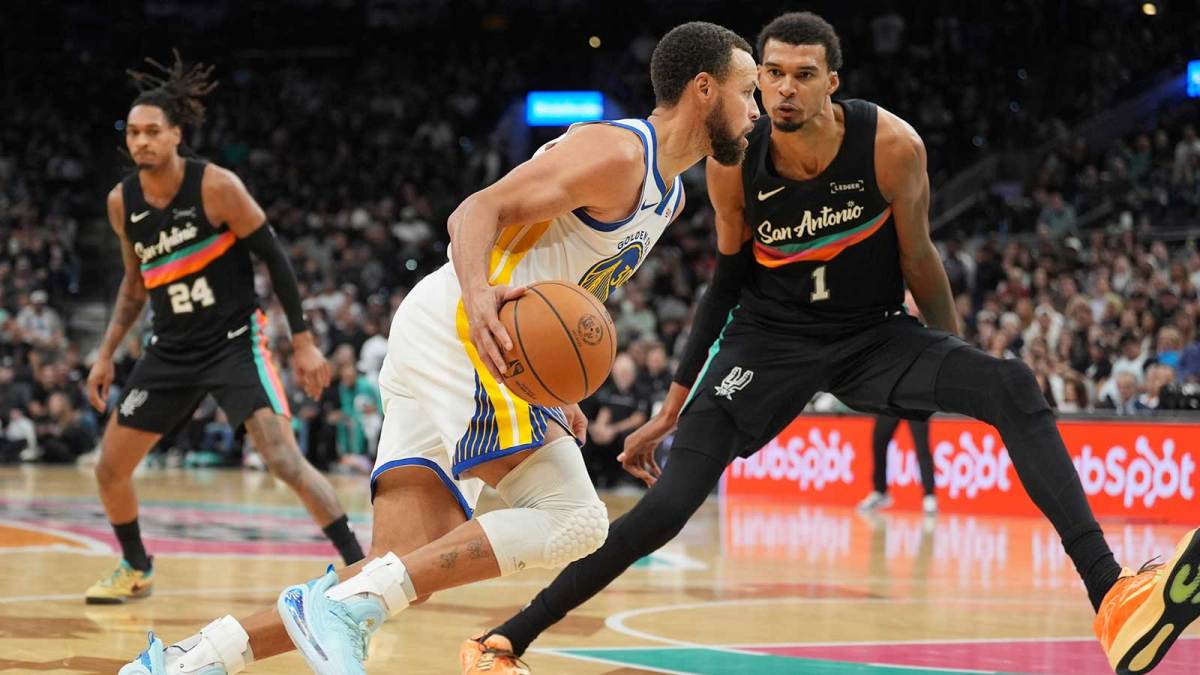 Golden State Warriors guard Stephen Curry (30) dribbles against San Antonio Spurs forward Victor Wembanyama (1) in the second half at Frost Bank Center.