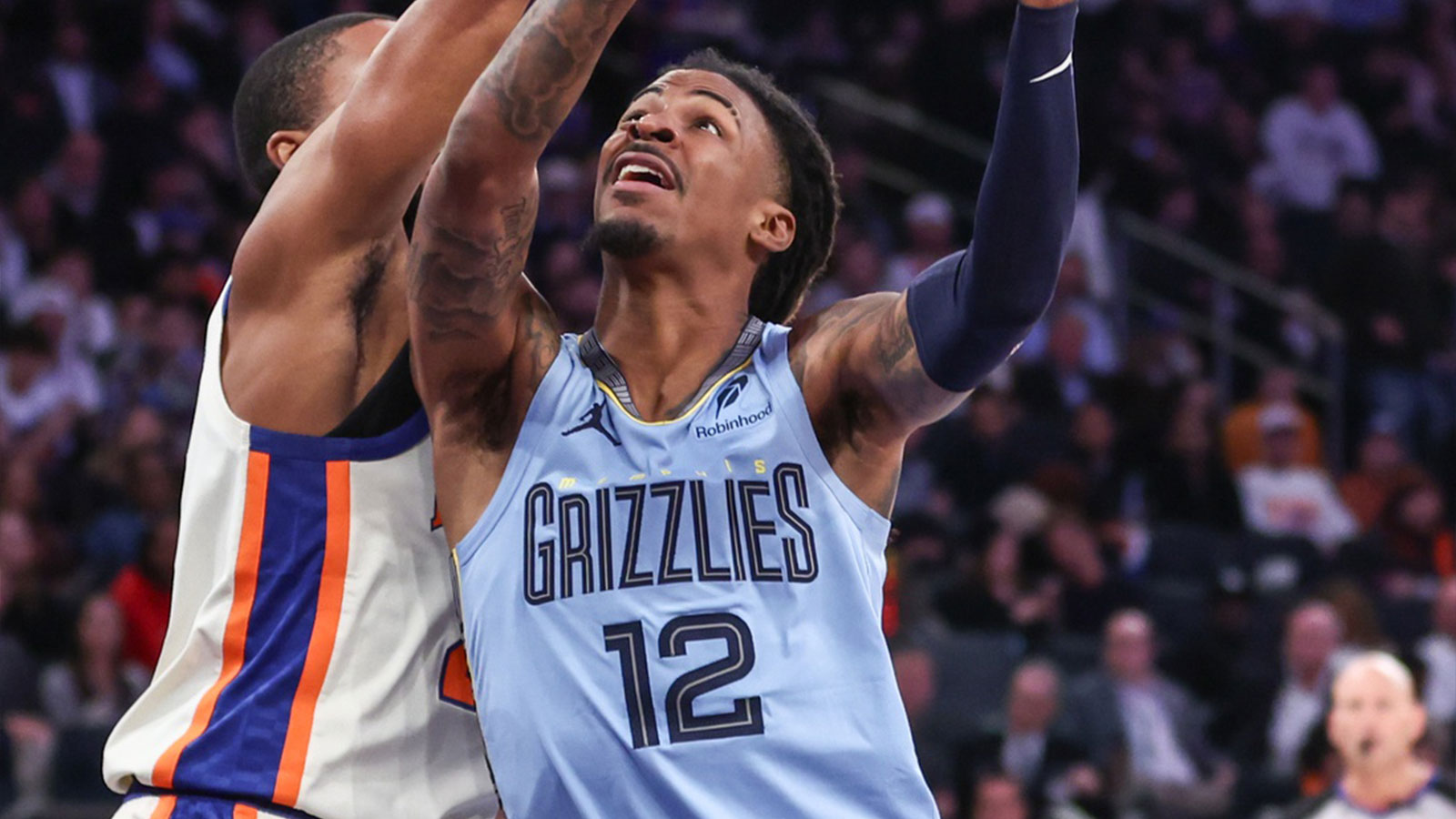 Memphis Grizzlies guard Ja Morant (12) looks to drive past New York Knicks guard Mikal Bridges (25) in the third quarter at Madison Square Garden.