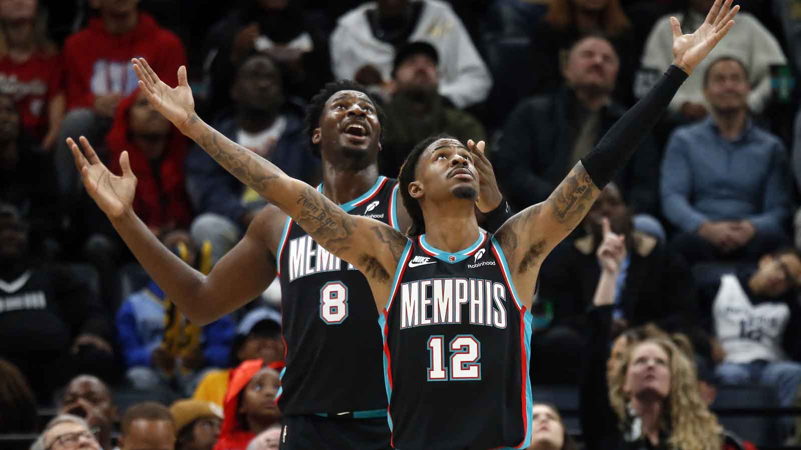 Grizzlies forward/center Jaren Jackson Jr. (8) and guard Ja Morant (12) react during the third quarter against the Oklahoma City Thunder at FedExForum